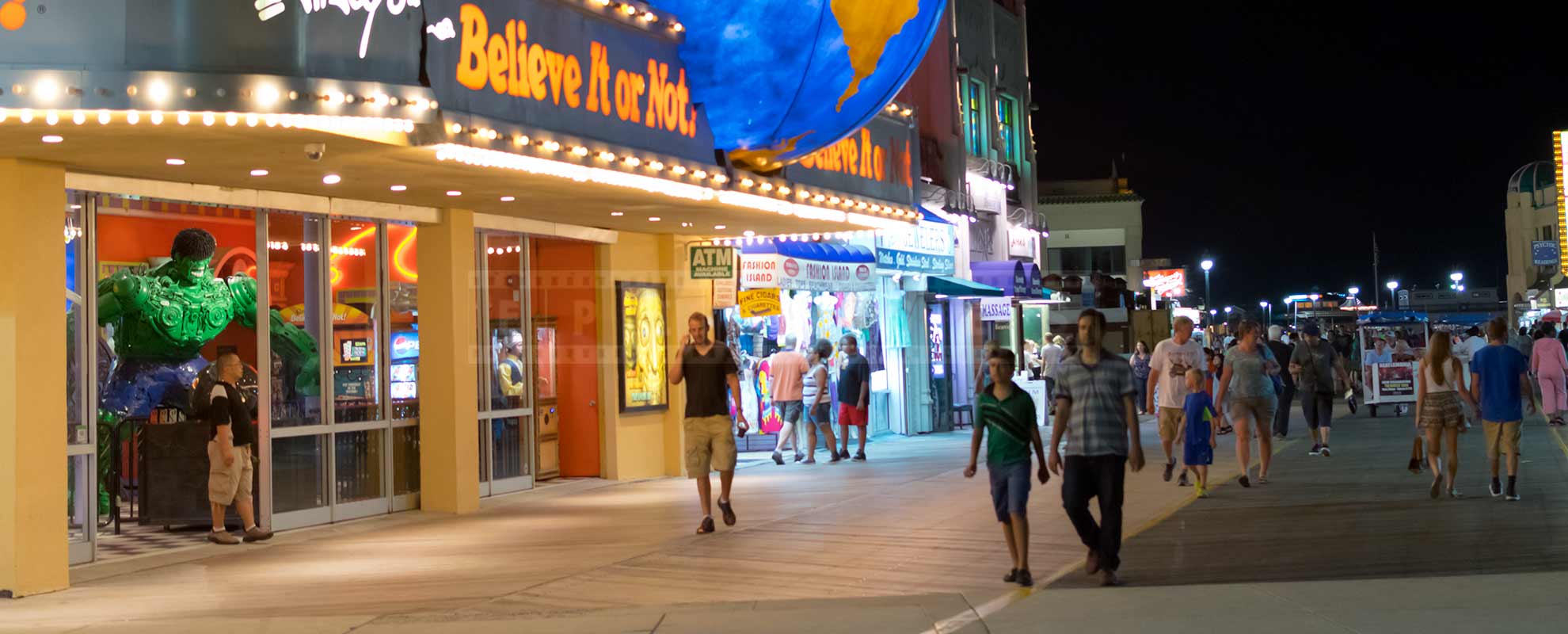Atlantic City boardwalk full of people at night